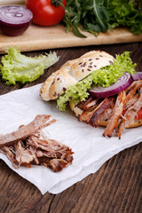 Pulled pork burger with coleslaw tomato, onion and fresh bread.