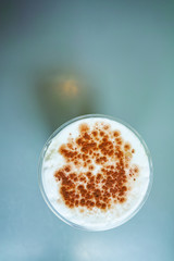 Ice Cappuccino in PET cup at cafe. Ice coffee in Vintage style cafe.