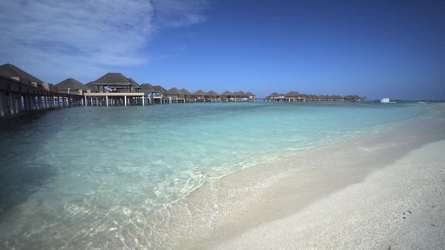 Waves Lap at White Sand at Luxury Resort