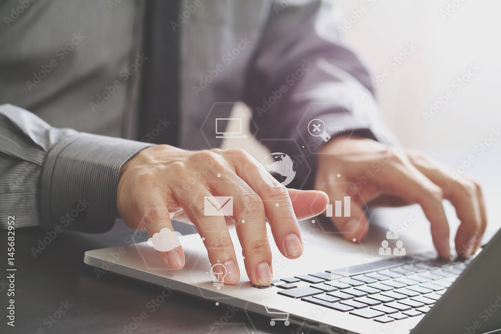 Poster close up of businessman working with laptop computer on wooden desk in modern office with virtual icon diagram