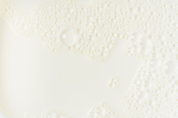 White milk or soy bubble foam background on top view close up - obrazy, fototapety, plakaty