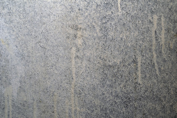 Grungy gray concrete wall with whitewash and vertical lines.