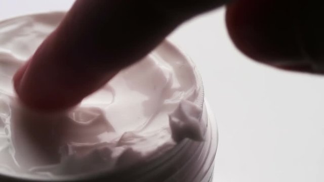 White gentle cosmetic cream Fingered,macro closeup