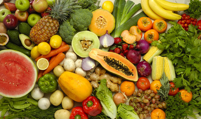 Buffet of many fruits and vegetables in a collection of food nutrition with overhead view showing color and variety.