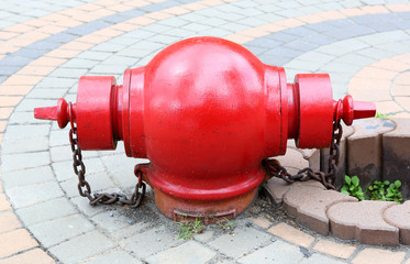 Red fire hydrant on a sidewalk.