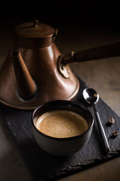 Close Up Of Coffee Cup With Retro Coffee Pot