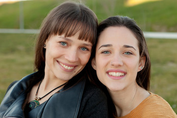 Outdoor portrait of two happy sisters