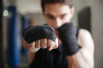 Close up  view of young boxer doing exercise in gym