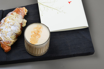 A cup of cappuccino coffee on a gray background