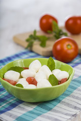 Caprese salad on a wooden table.