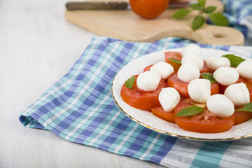 Caprese salad on a wooden table.