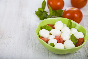 Caprese salad on a wooden table.