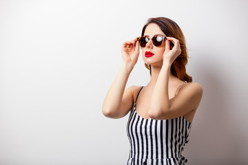 portrait of beautiful young woman standing on the wonderful white studio background