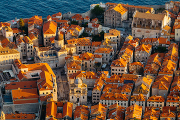 View from above on red tile on the roofs of houses and Assumption Cathedral in the old town in Dubrovnik, Croatia.