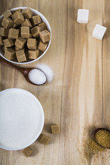 Different kind of white and brown sugar on old brown table