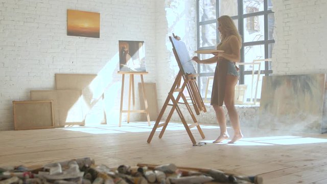 Oil paints in tubes lie on the table with tassels in art workshop