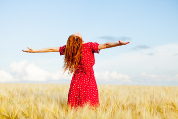 photo of beautiful young woman on the wonderful wheat field background © Masson