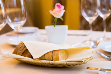 Beautifully decorated table in the restaurant. On the table is a plate of bread