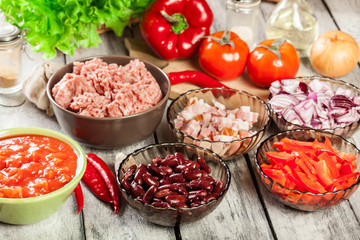 Ingredients ready for preparing chili con carne. Mincemeat, papr