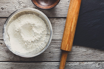 Baking concept. Flour and rolling pin on wood