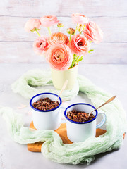 Red quinoa with vegetables in enamel mugs. Vegetarian gluten free lunch