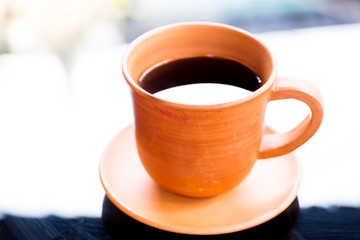 Black coffee in cray cup close up.