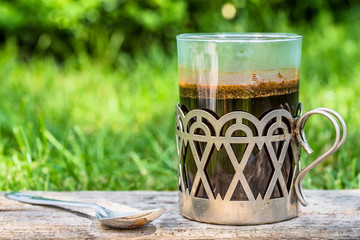 Glass coffee cup in the garden, summer outdoor theme