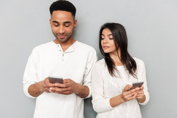 Woman looking in man's phone