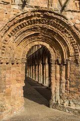 Obraz premium Crumbling stone arched doorway leading to a corridor 