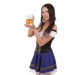 young woman in traditional bavarian dress holding mug of beer.