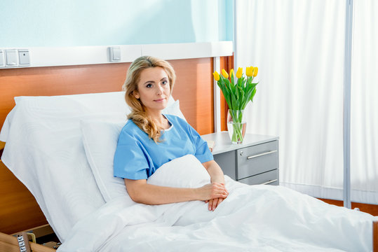 Pensive Woman Lying In Hospital Bed