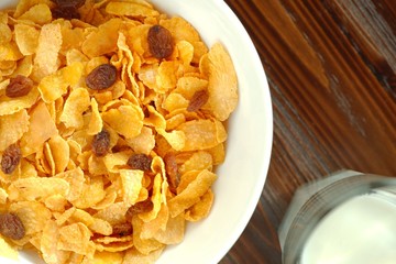 Healthy breakfast with a bowl of cornflakes and a glass of milk. Top view flat lay