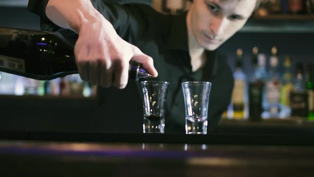 The barman prepares a cocktail and sets it on fire 4k