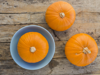 three pumpkins on wooden background