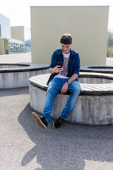 Fototapeta premium Young man checking his smartphone