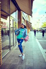 Naklejka premium Woman wearing sunglasses and a blue coat .