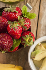 strawberry banana fruits on wood table
