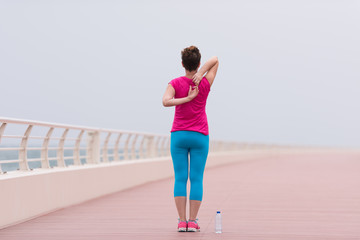 woman stretching and warming up on the promenade