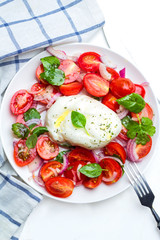 Burrata with basil and tomatoes.