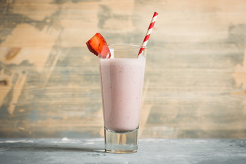 Strawberry milkshake on the rustic background. Shallow depth of field.