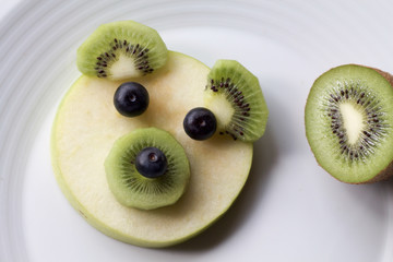 close up of bear face made of fruits