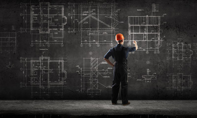 Obraz premium Builder man draw project . Mixed media