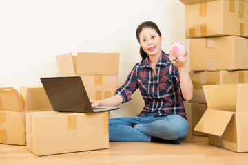 woman research for moving with money piggy