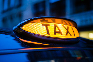 An illuminated taxi sign