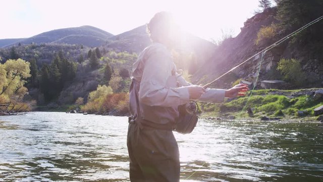 man flyfishing in river