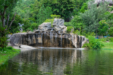 Fototapeta na wymiar Waterfall and a lake in a park at Orchid Island, Vietnam