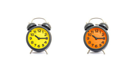Closeup yellow alarm clock and orange alarm clock for decorate show a quarter past ten o'clock or 10:15 a.m. isolated on white background