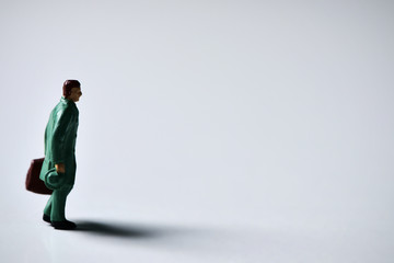 Fototapeta premium miniature traveler man with suitcase