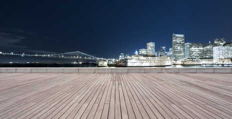 empty wooden floor with cityscape of modern city