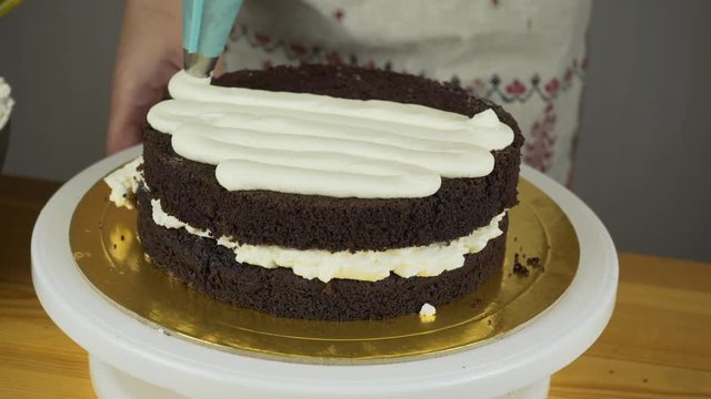 Pouring frosting on Cake. Making Chocolate Layer Cake. Series.